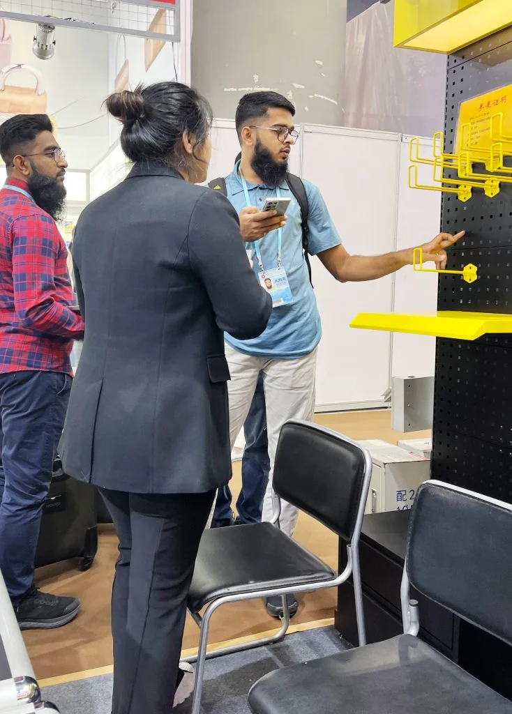 Visitors discussing shelving solutions at the Suzhou Jinta booth